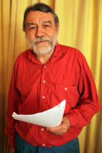 Photograph of man holding some paper