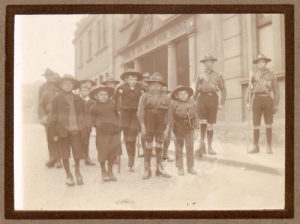 sepia photo of a group of disabled people dressed in uniform