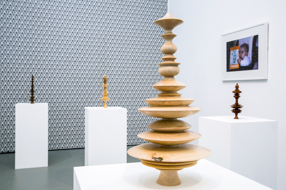 Photo of a turned wooden sculpture pictured in a gallery 